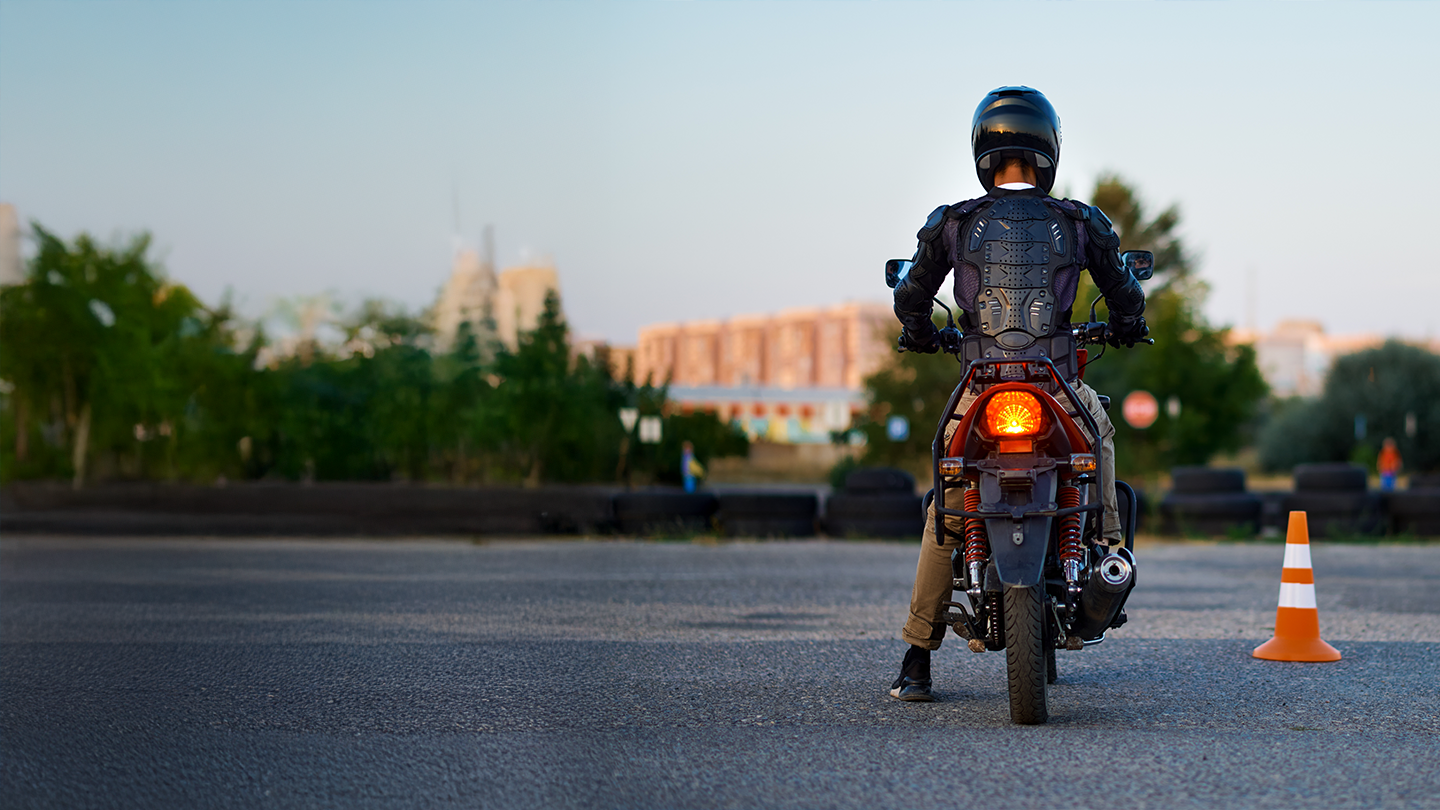 Motorcyclist in full safety gear practicing on a training course